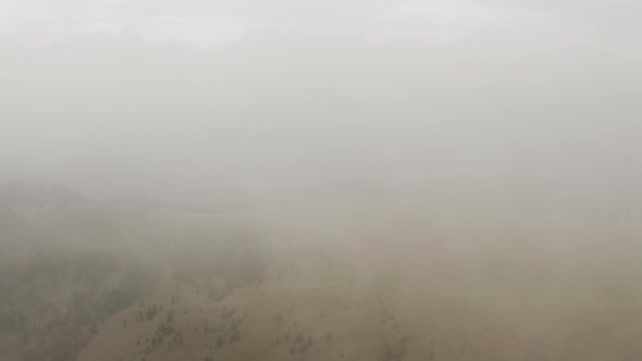 Flying from white cloud over autumn mountain transition from white, Aerial shot, Slovakia