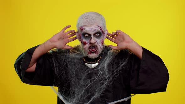 Sinister Man Scary Halloween Zombie Making Playful Silly Facial Expressions Grimacing Fooling Around