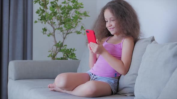 Curious Cute Boy Preschool Child Using a Digital Tablet Technology Device Looks telephone