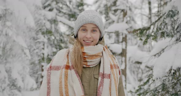Portrait of Cute Female Student Laughing Having Fun with Snow in Winter Forest