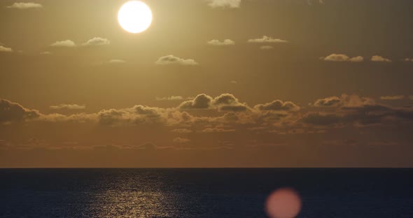 Colorful sunset at the sea, Against the background of the sea, sun goes down