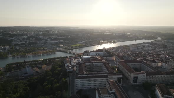 Coimbra University and Mondego river with landscape in background, Portugal. Aerial forward