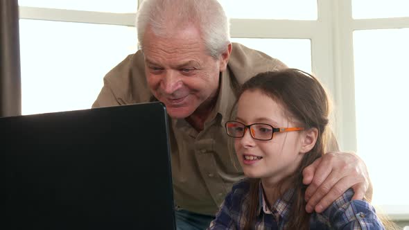 Little Girl and Her Grandpa Have Video Chat on Laptop