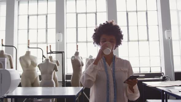 Mixed race woman working in fashion office