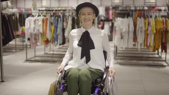 Portrait of Woman in Wheelchair Posing in Clothing Store