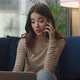 Attractive Young Woman is Speaking on Smartphone with Client From Home - VideoHive Item for Sale