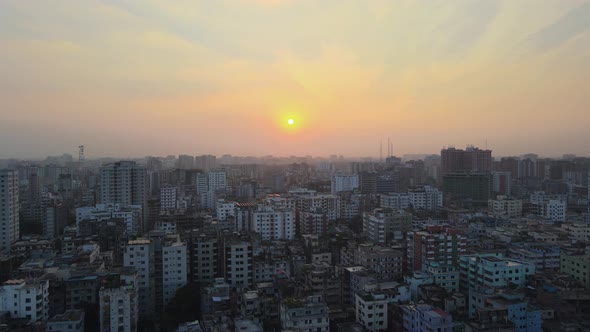 Panoramic views over Dhaka city during golden sunset; drone dolly in