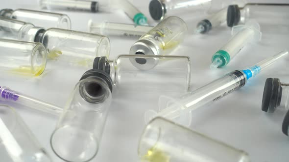 Syringes and ampoules on a white background.