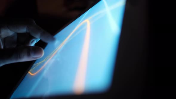 Man's Hand Working on Digital Tablet at Office Desk Using Self Created Chart