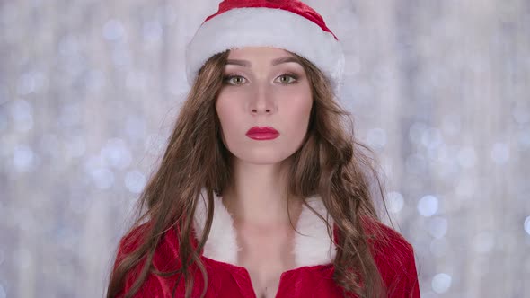 Santa Girl Starts Smiles. Bokeh Background. Slow Motion