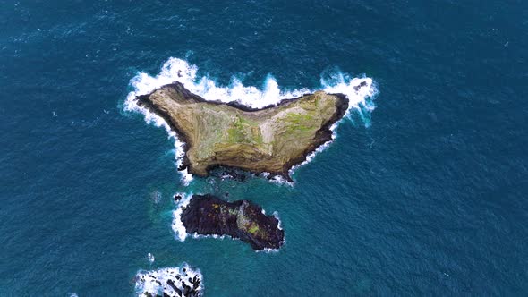 Top-down aerial view over rocky island, Ilheu Mole, Porto Moniz, Madeira