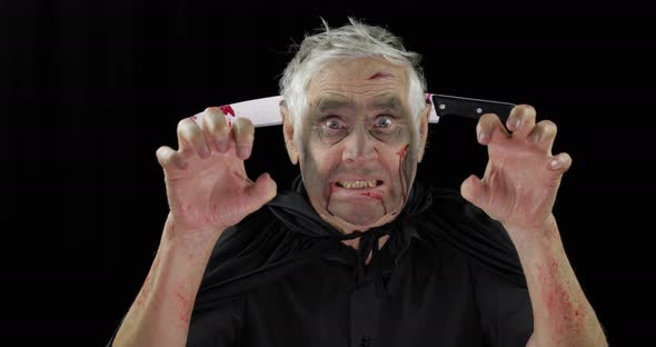 Elderly Man with Knife in Head. Halloween Makeup and Costume. Blood on His Face