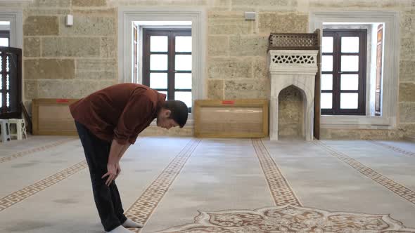 Young Man Bowing While Prayer