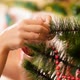 Closeup Video of Female Hands Hanging Colorful Bauble on Christmas Tree - VideoHive Item for Sale