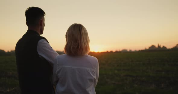 A Couple of Farmers are Looking at Their Field