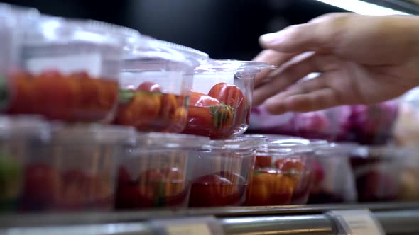 Man's hand with tomato