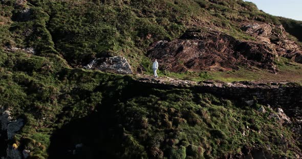 Girl on a Cliff By the Ocean