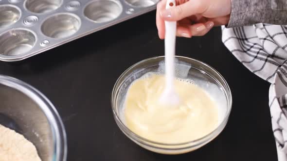 Step by step. Baking cornbread muffins in metal muffin tin.