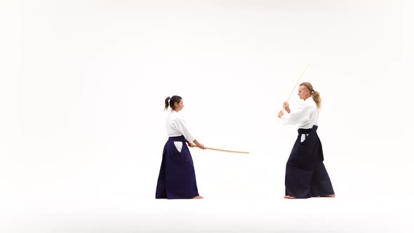 Man and Woman Practicing Aikido Using Bokken