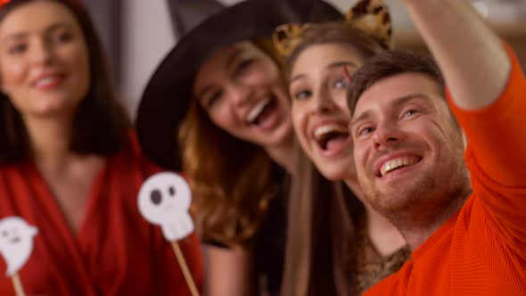 Happy Friends in Halloween Costumes Taking Selfie