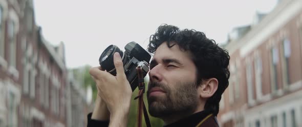 Man taking pictures of a building in the city