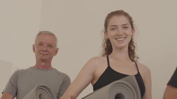Portrait of Active Seniors and Fitness Instructor with Yoga Mats