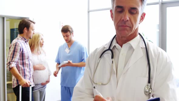 Portrait of male doctor holding a medical report