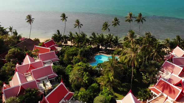 Oriental Houses on Seashore. Drone View of Lovely Oriental Cottages and Green Coconut Palms