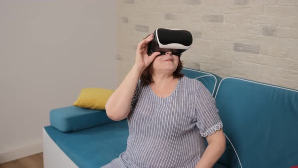 Senior Woman Wearing Virtual Reality Headset. Augmented Reality.