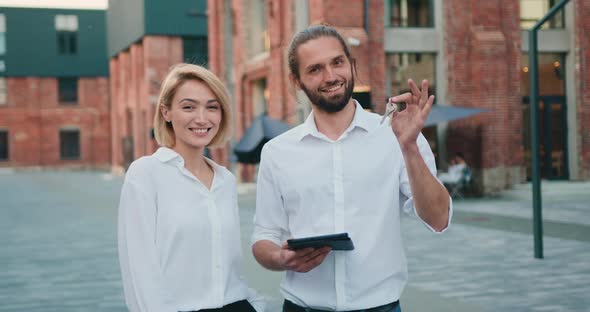 Portrait Happy Caucasian Couple on the Background of their New Home.