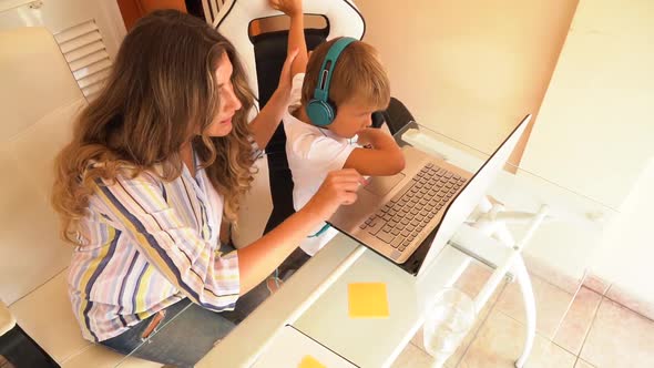 Mother Working Home with Son