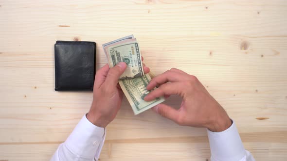 Hands counting dollar banknotes