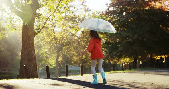 Girl having fun outdoors with umbrella