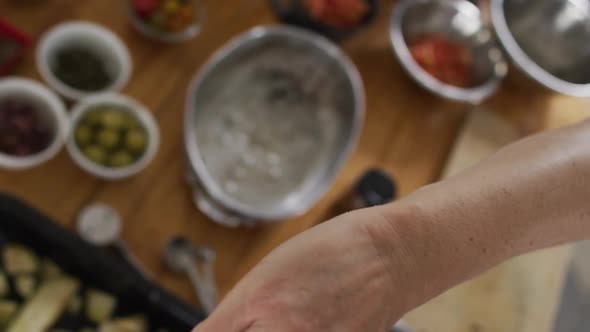 Caucasian female chef teaching diverse group wearing face masks