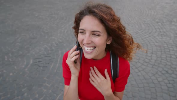 Ecstatic Woman Talking on Phone Outdoors