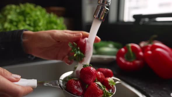 Woman Hands Washing Strawberries in the Kitchen