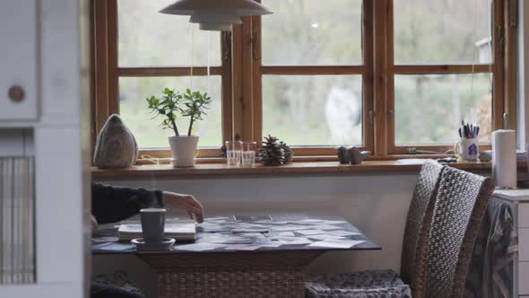 Mature Man Arranging Scattered Photographs