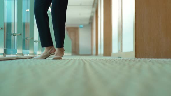 Businesswoman feet waiting in the hallway.