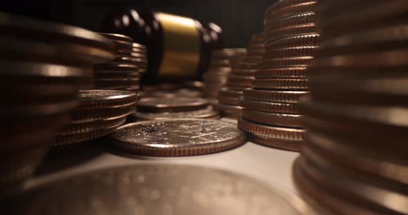 Stacks of Coins and Wooden Judge Gavel