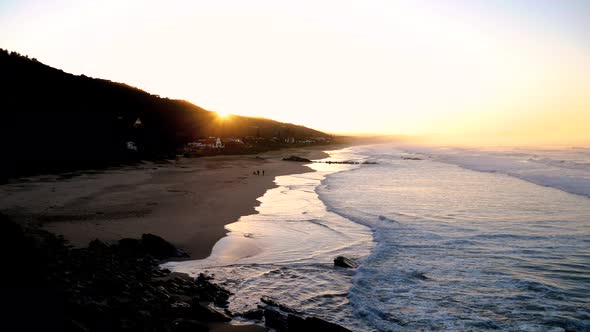 Sunrise over the wide stretch of beach of Wilderness, South Africa.