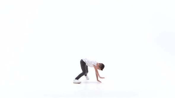 Little Boy Is Dancing a Modern Dance on the White Background in Black Leather Jackets and Jeans