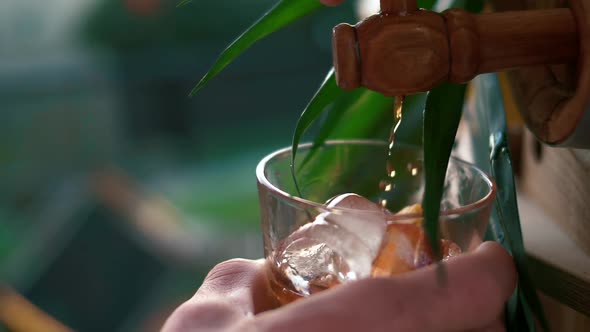 Expensive Irish whiskey poured into the rock with ice from a wooden keg