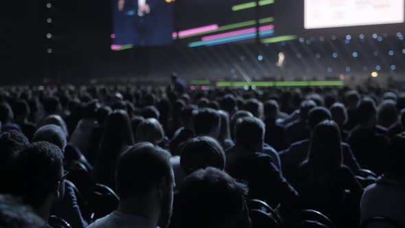 Spectators Sit on Seats in Break of Concert