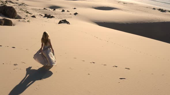 Drone Of Woman Walking On Sandy Beach