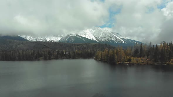 Aerial View of Strbske Pleso in the Clouds and Snowy Mountains. Slovakia