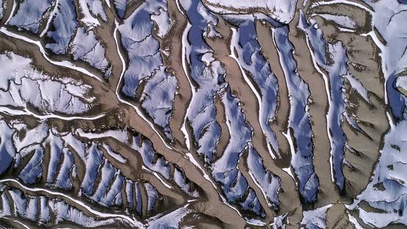 Aerial view of desert terrain texture with the sun melting the snow