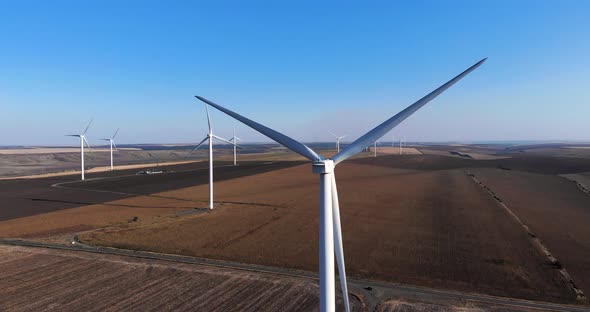 Windmills At A Wind Farm Against Blue Sky