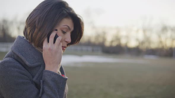 Business Woman Walking and Talking on the Phone