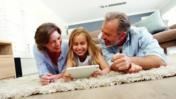 Family using digital tablet in living room