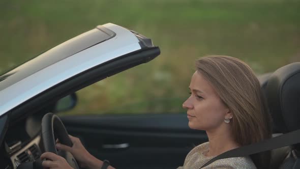 Girl Driving a Cabriolet Car